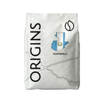 Coffee bag labeled 'Origins Guatemala' with a map design on a dark background